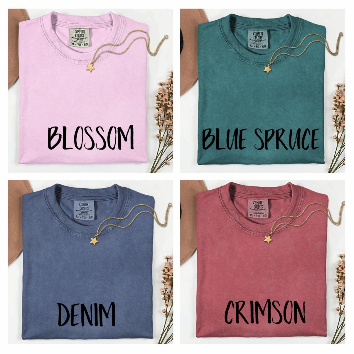 The image is a collage of four images, each showing a different color of a t-shirt with a label indicating the color and the word "BLOSSOM" written on it.